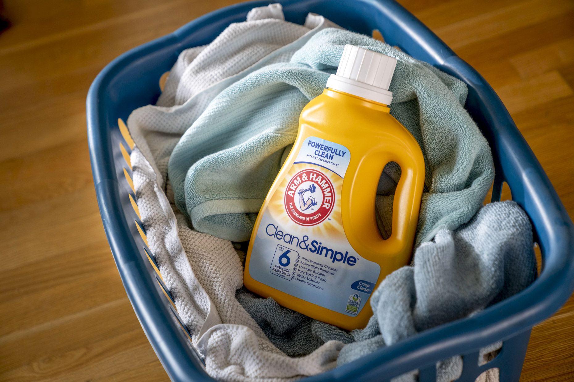 Arm and Hammer laundry soap in basket of towels 