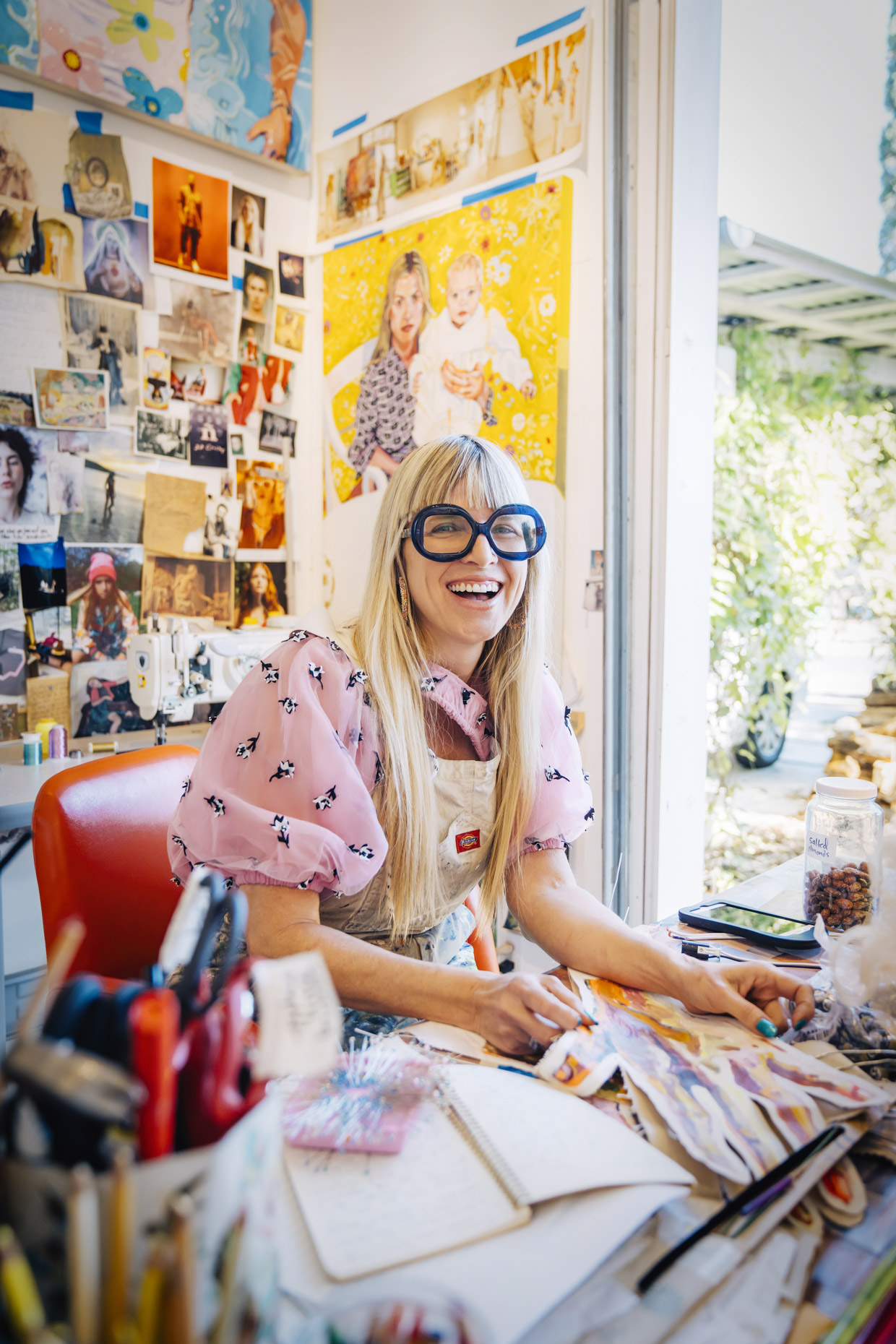 Artist painter Elizabeth Chapin sitting in her studio laughing 