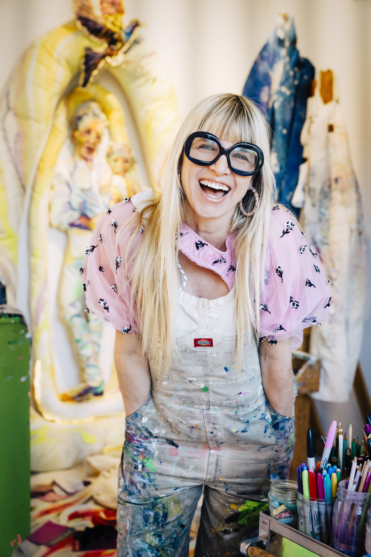 Artist painter Elizabeth Chapin laughing in her studio