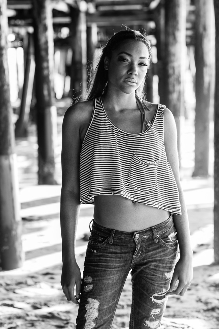 Black and white portrait of woman in striped crop top and jeans