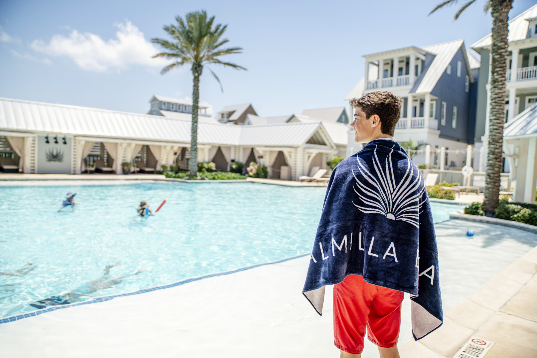 Boy in towel looking at Palmila Resort pool