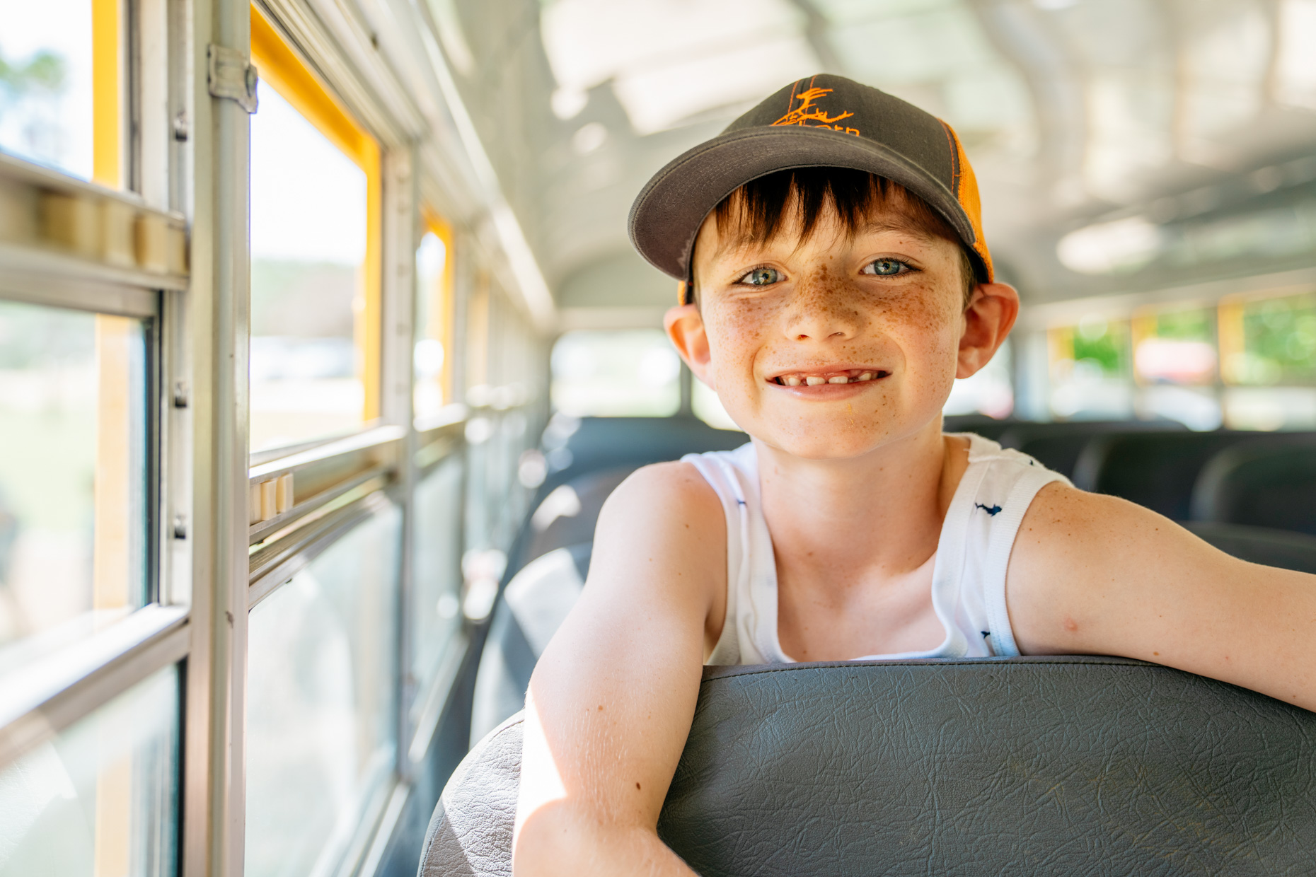 Boy-smiling-on-school-bus-is20210716_Deer_Creek_0708