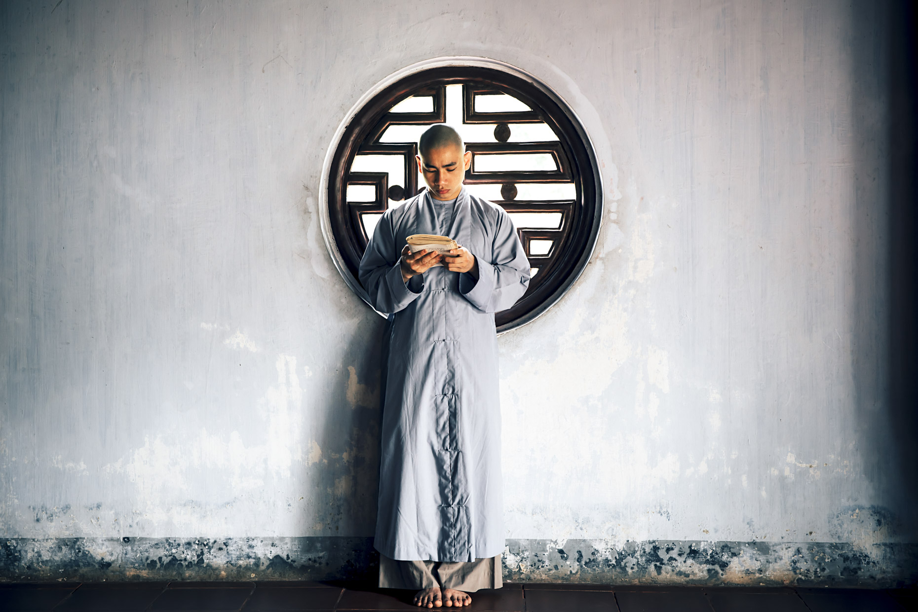 Buddhist Monk standing and reading in Vietnam