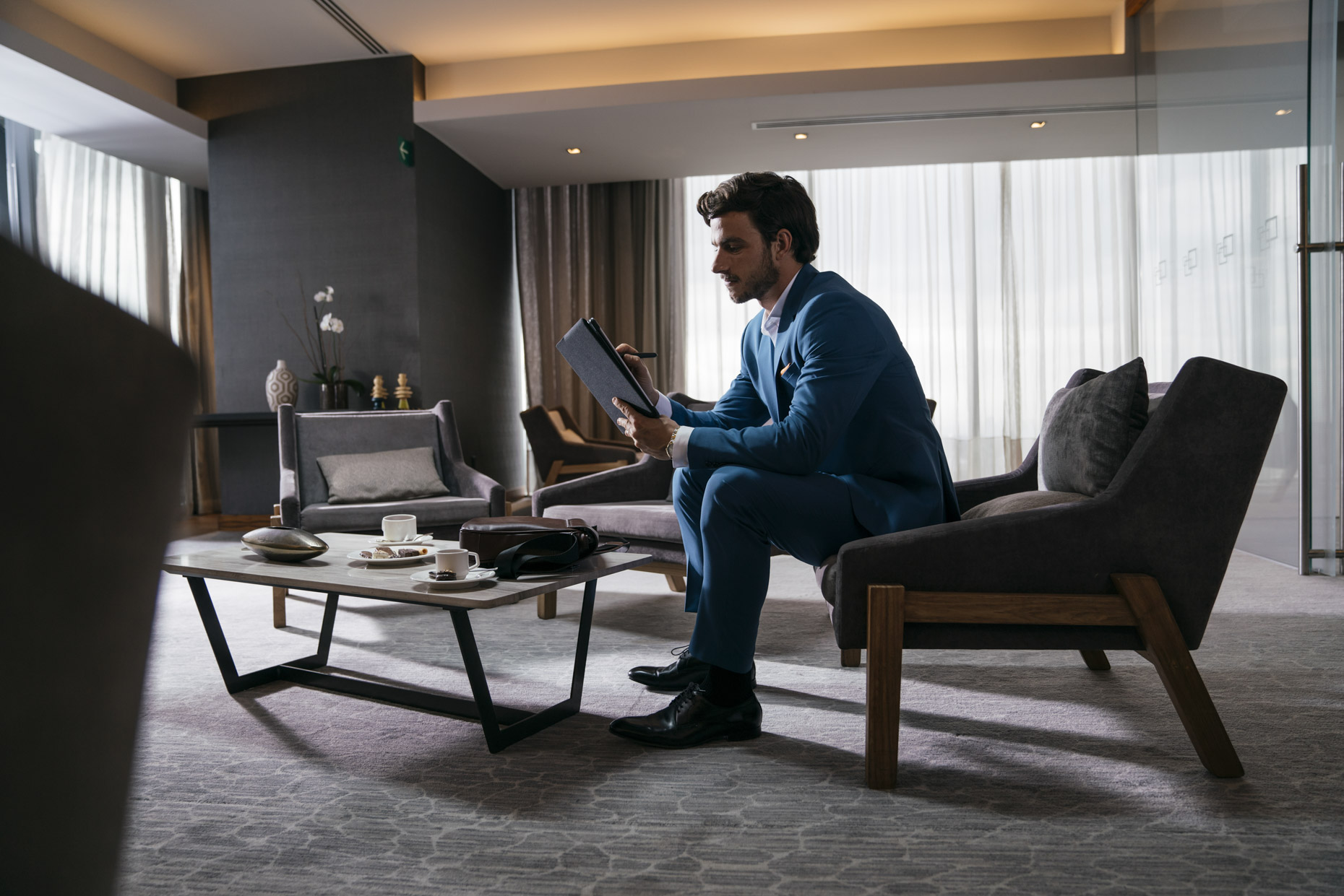 Business man working on iPad in hotel meeting center