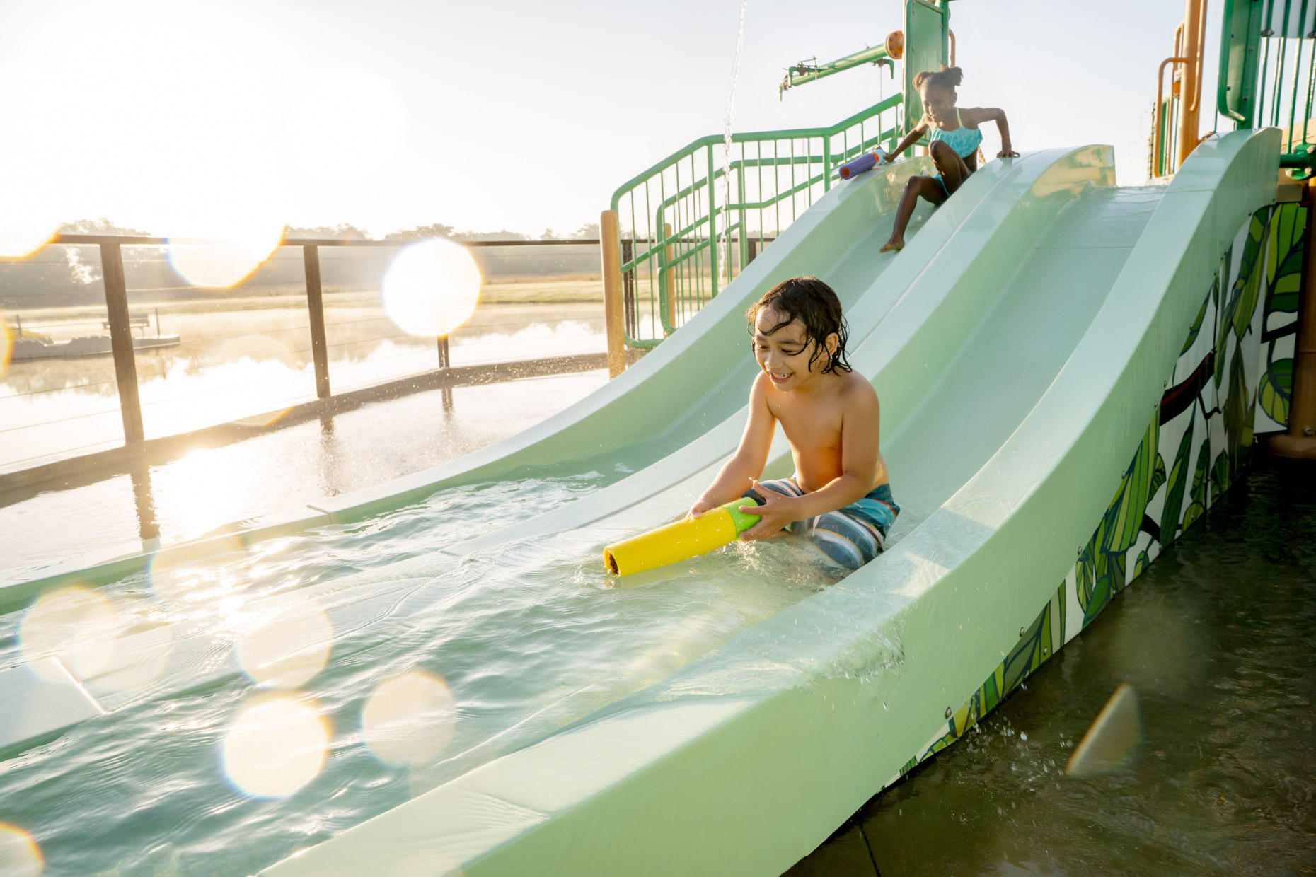Children playing on slide at restort water park