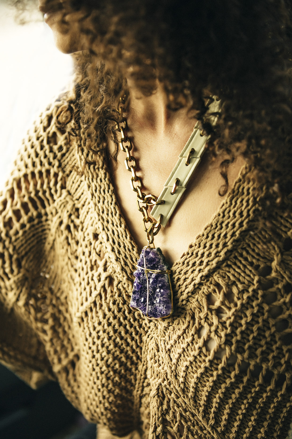 Close up of Belthazzar Jewels necklace with leather brass and purple crystal