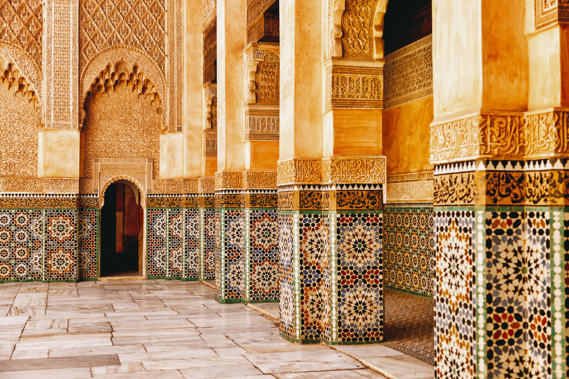 Colorfuly tiled Ben Youssef Madrasa college courtyard in Marrakesh Morocco