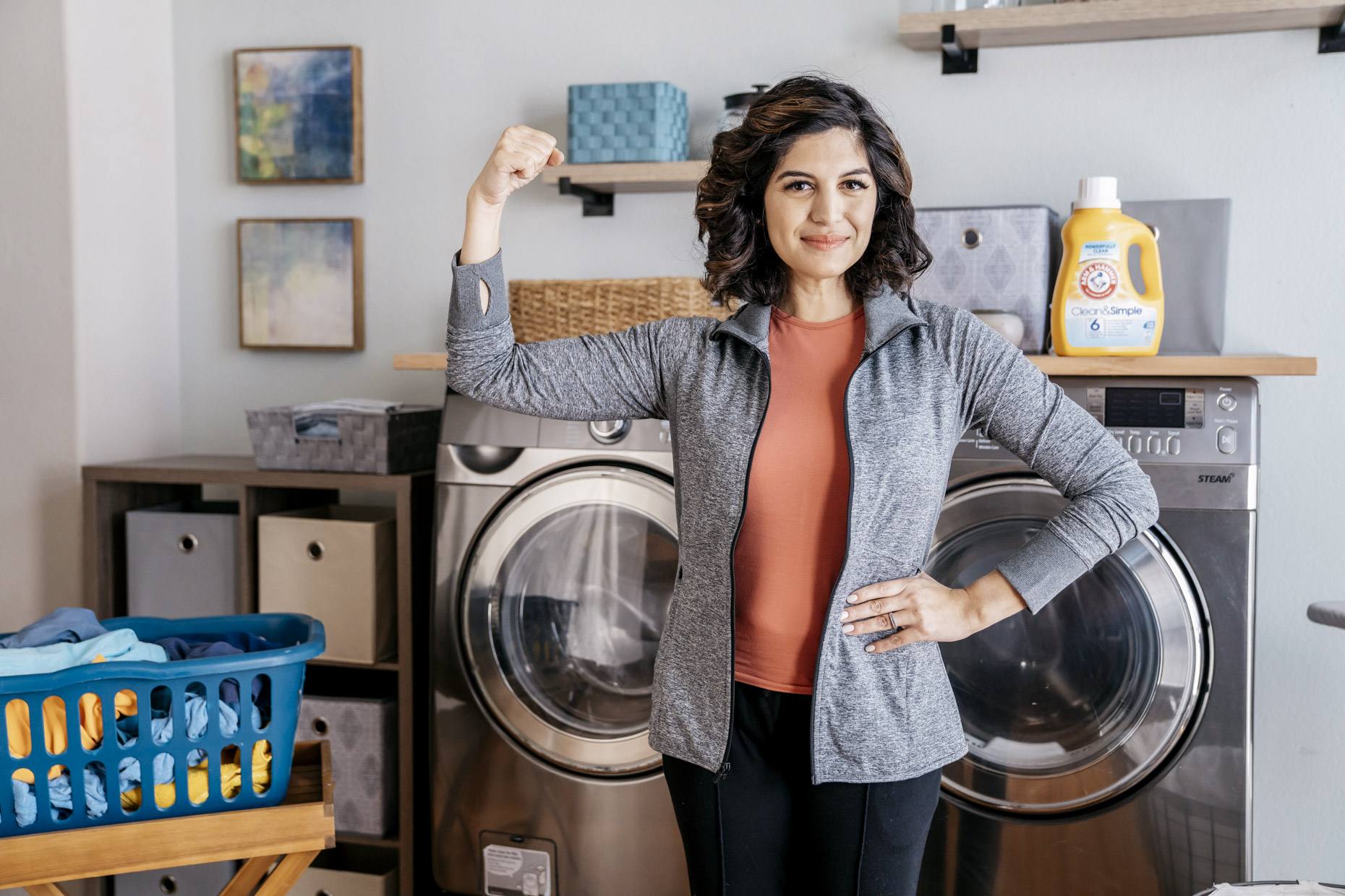 Confident woman with arm raised for Arm and Hammer Laundry detergent