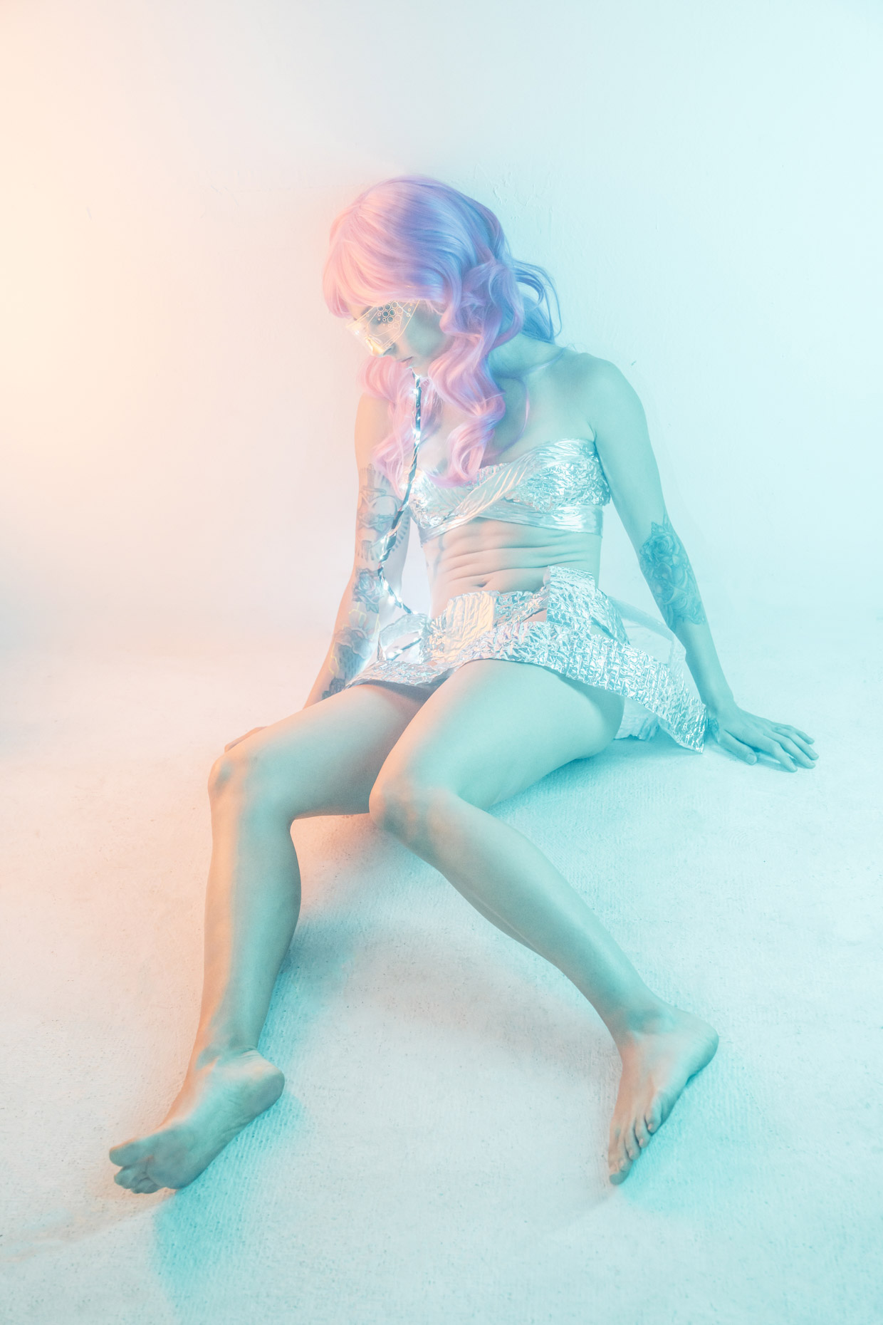 Cyber punk musician Le Destroy with pink hair silver metallic outfit with LED lights and lit glasses