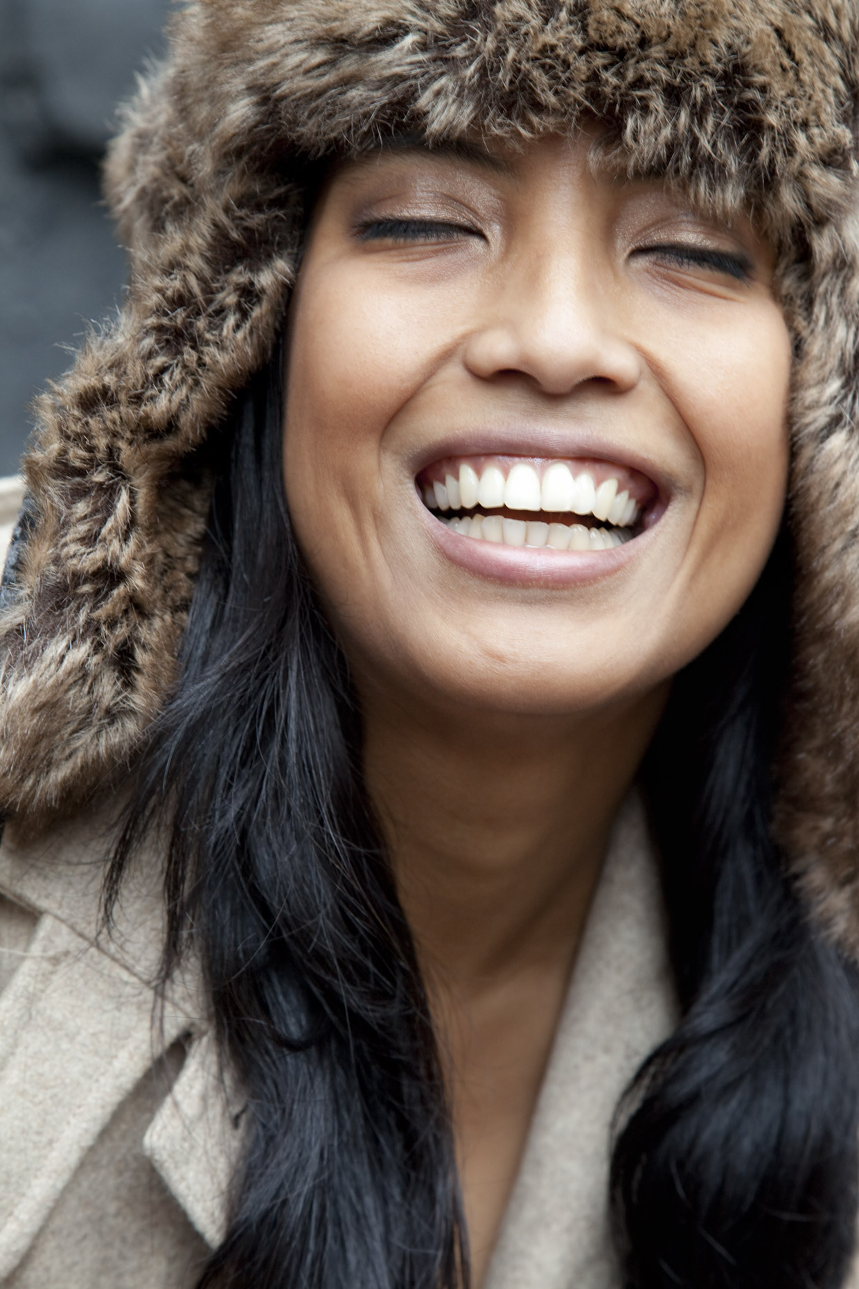 Indian woman in fur hat laughing