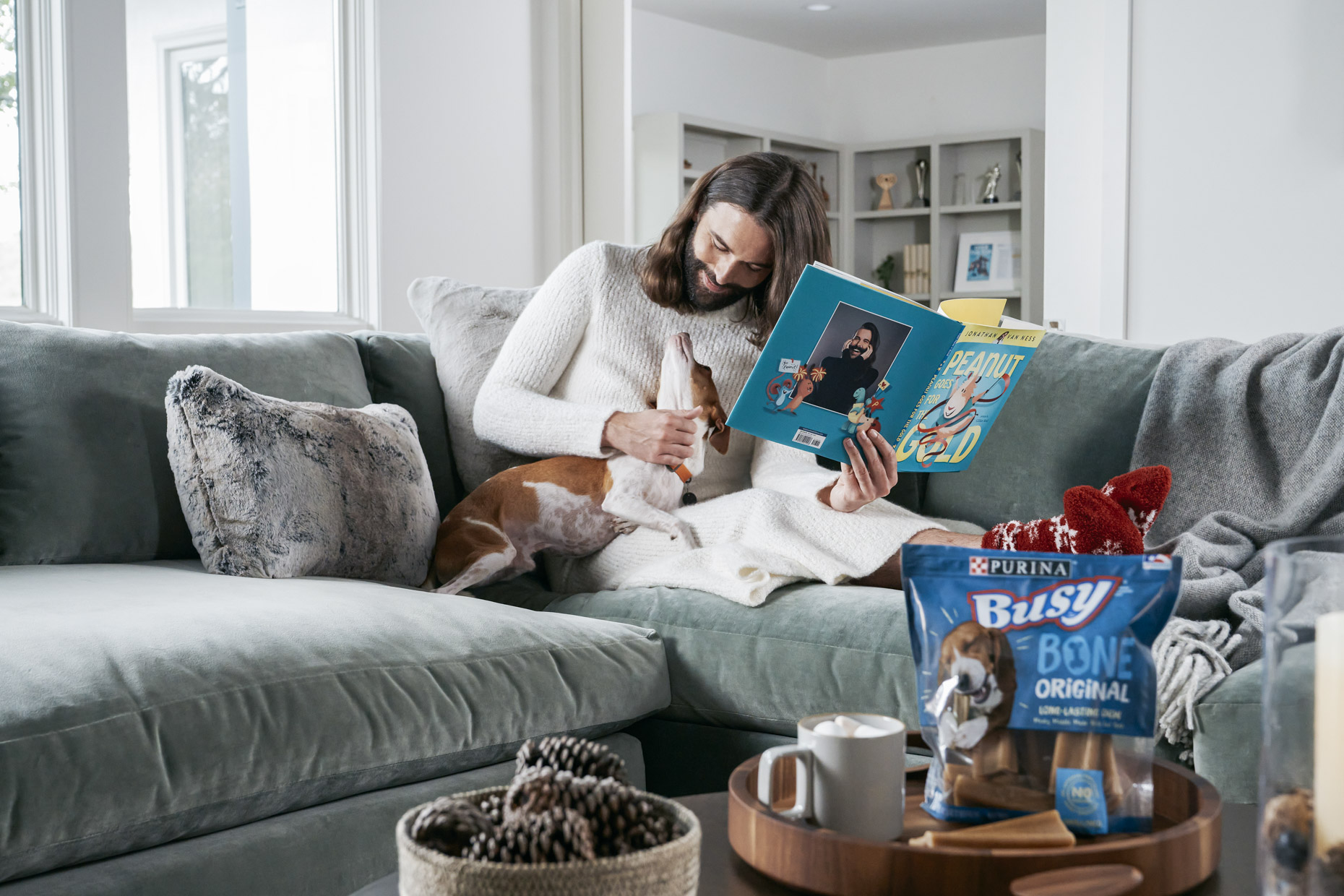 Jonathan Van Ness pet dog Pablo on couch with Purina Busy Bone treat
