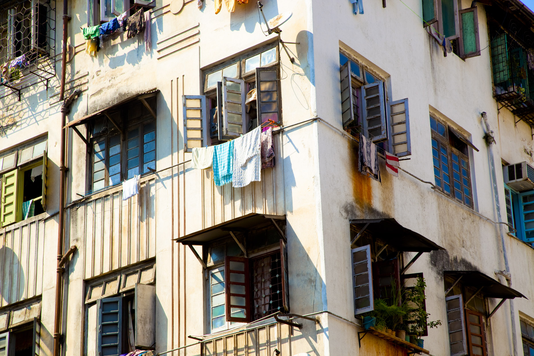 Laundry hanging out of windows of apartment building in India