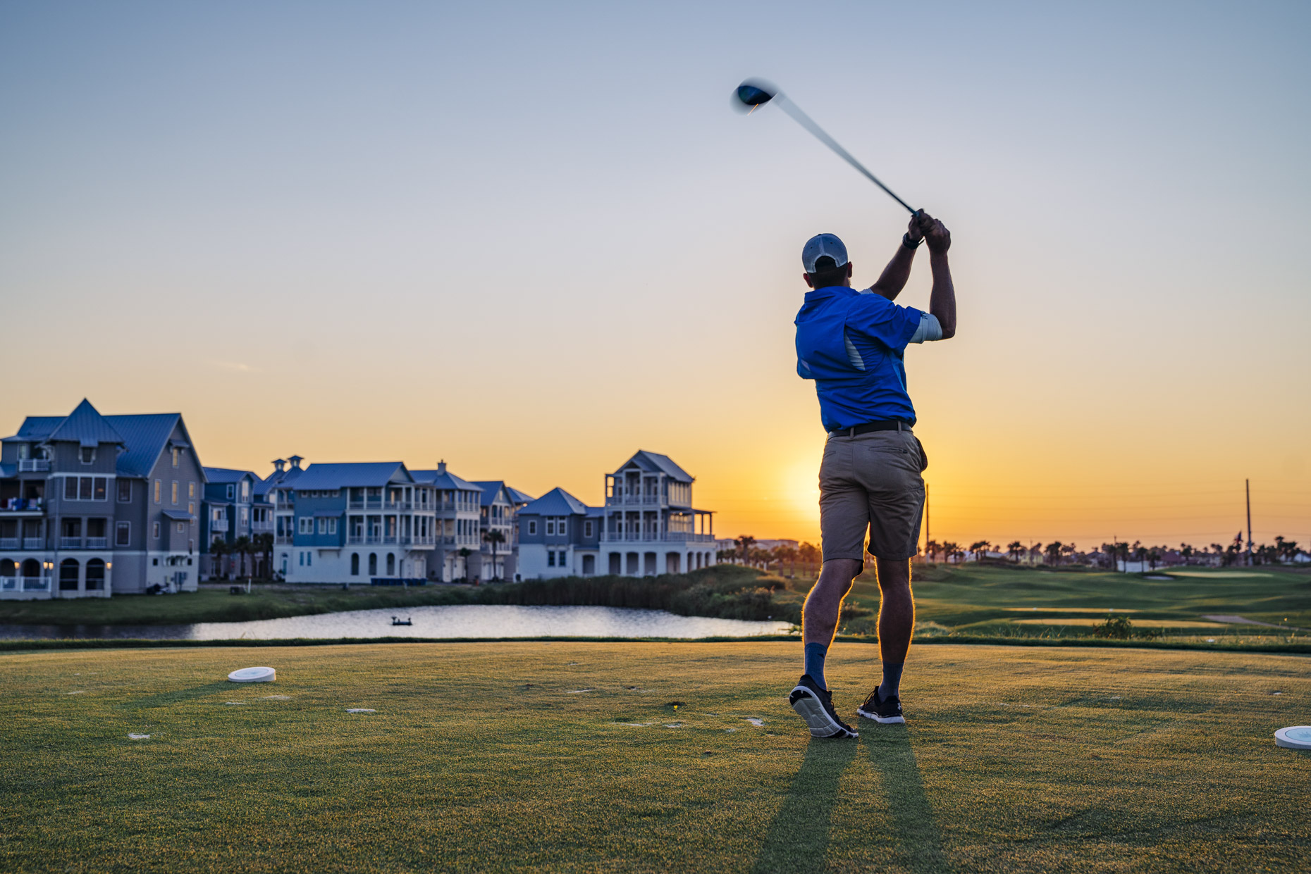 Man golfing at sunset at Palmilla Resort
