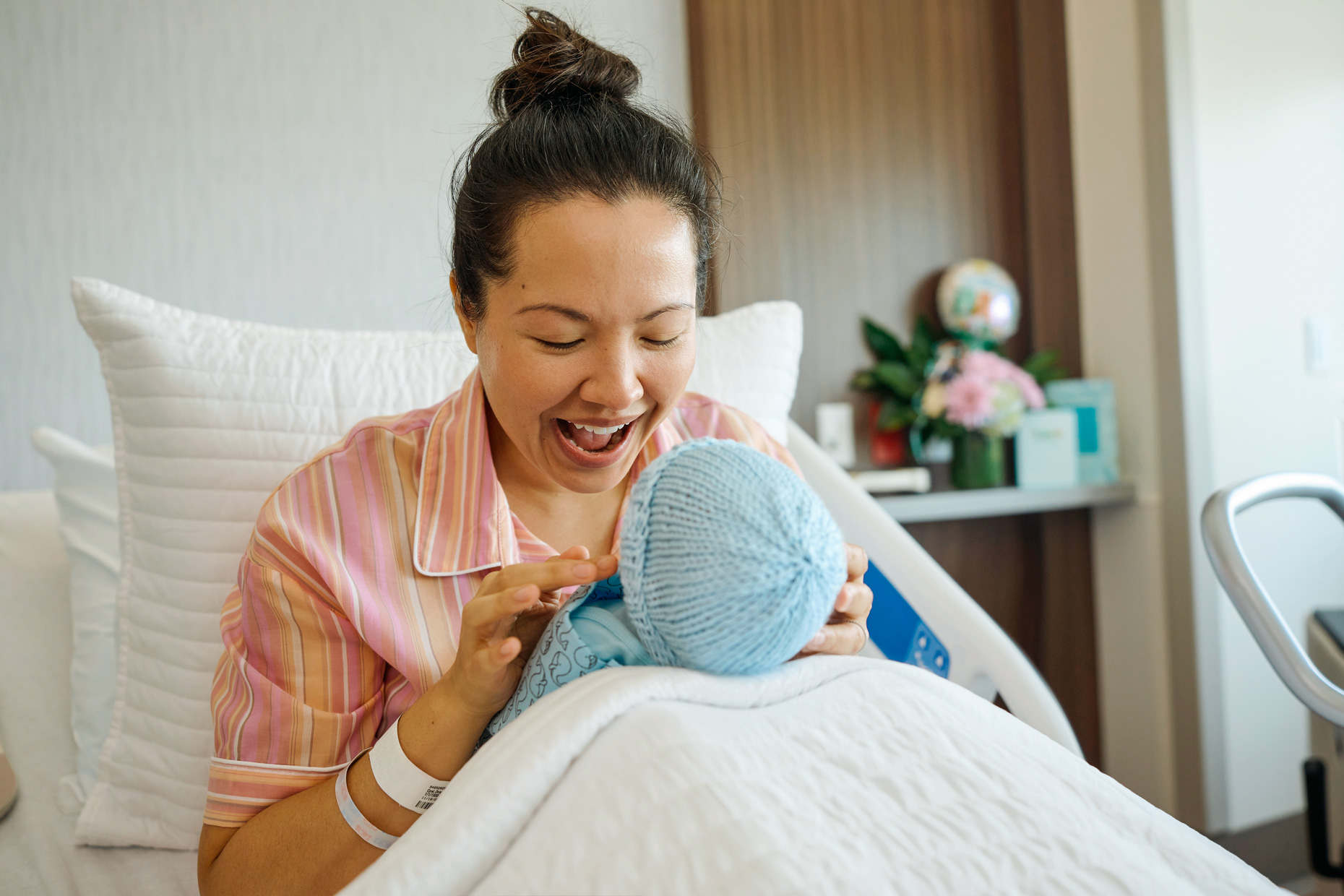 Mom-smiling-playing-with-new-baby-in-delivery-20220718_THR_DENTON_04_PATIENT_BABY_1740