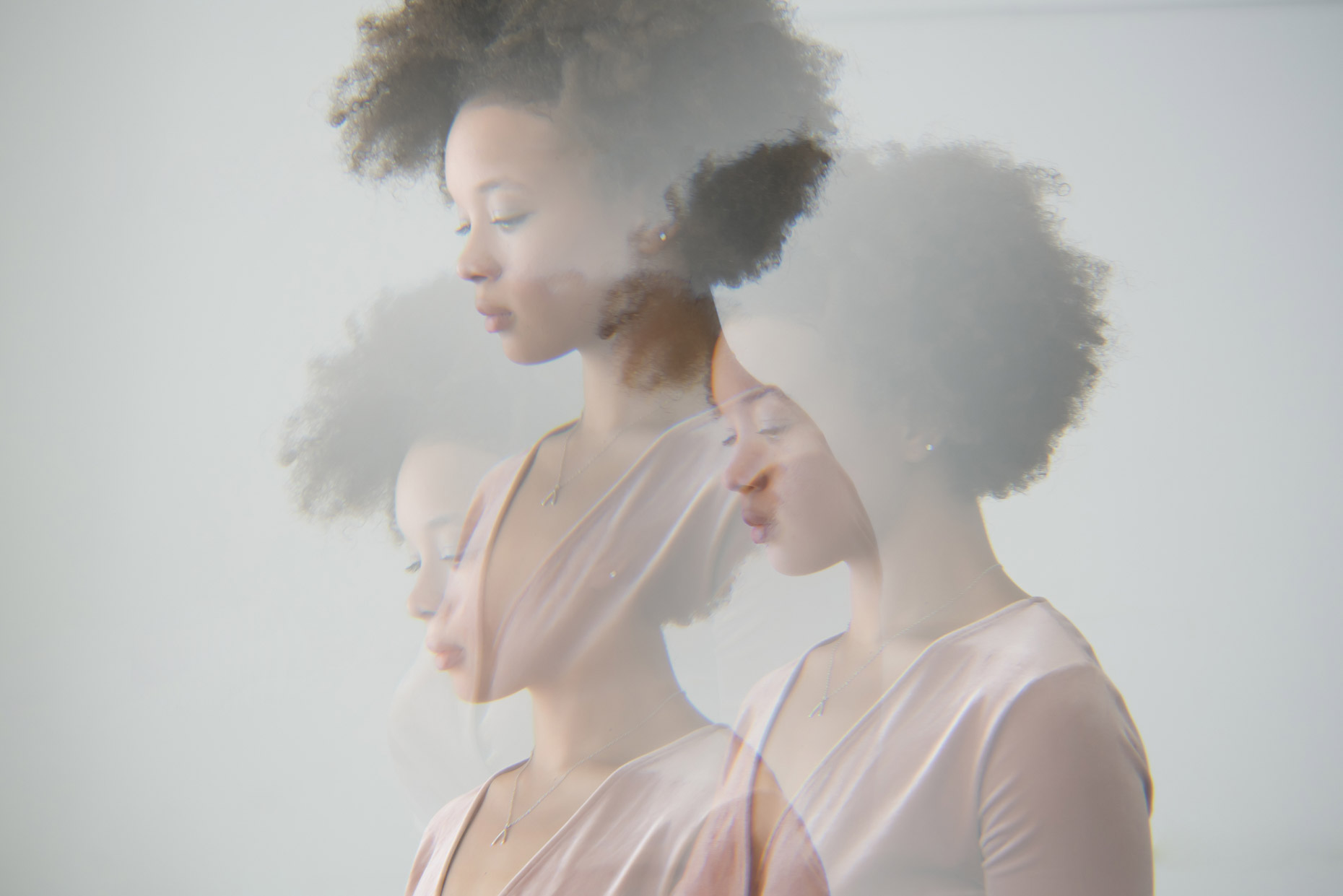 Multiple exposure profile portrait of woman with afro