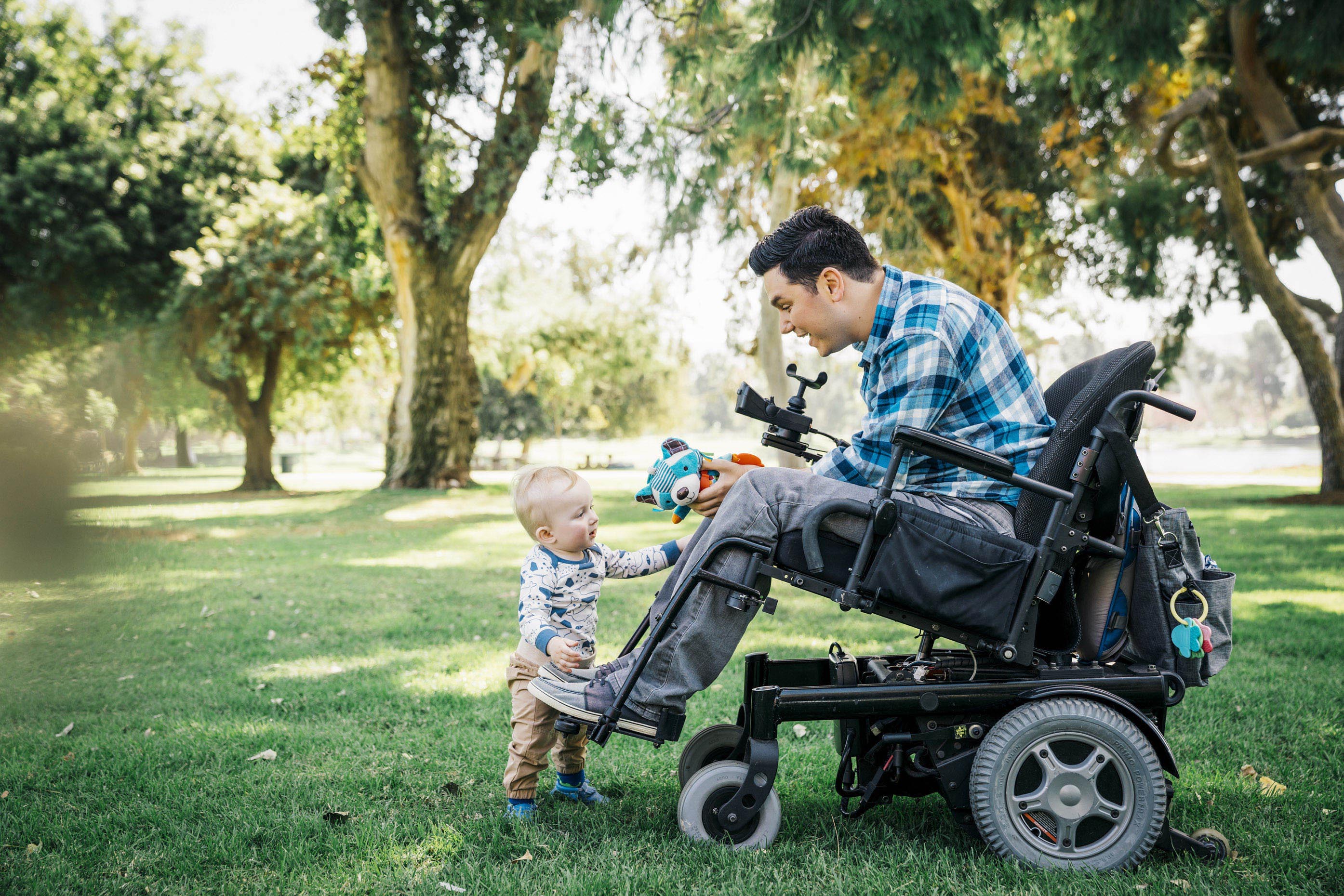 Parapalegic-man-in-wheel-chair-playing-with-baby-in-park-Inti-St-Clair-17OCT_8743