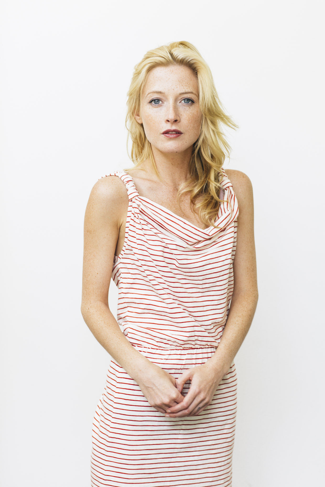 Portrait of beautiful blonde woman in red and white striped dress