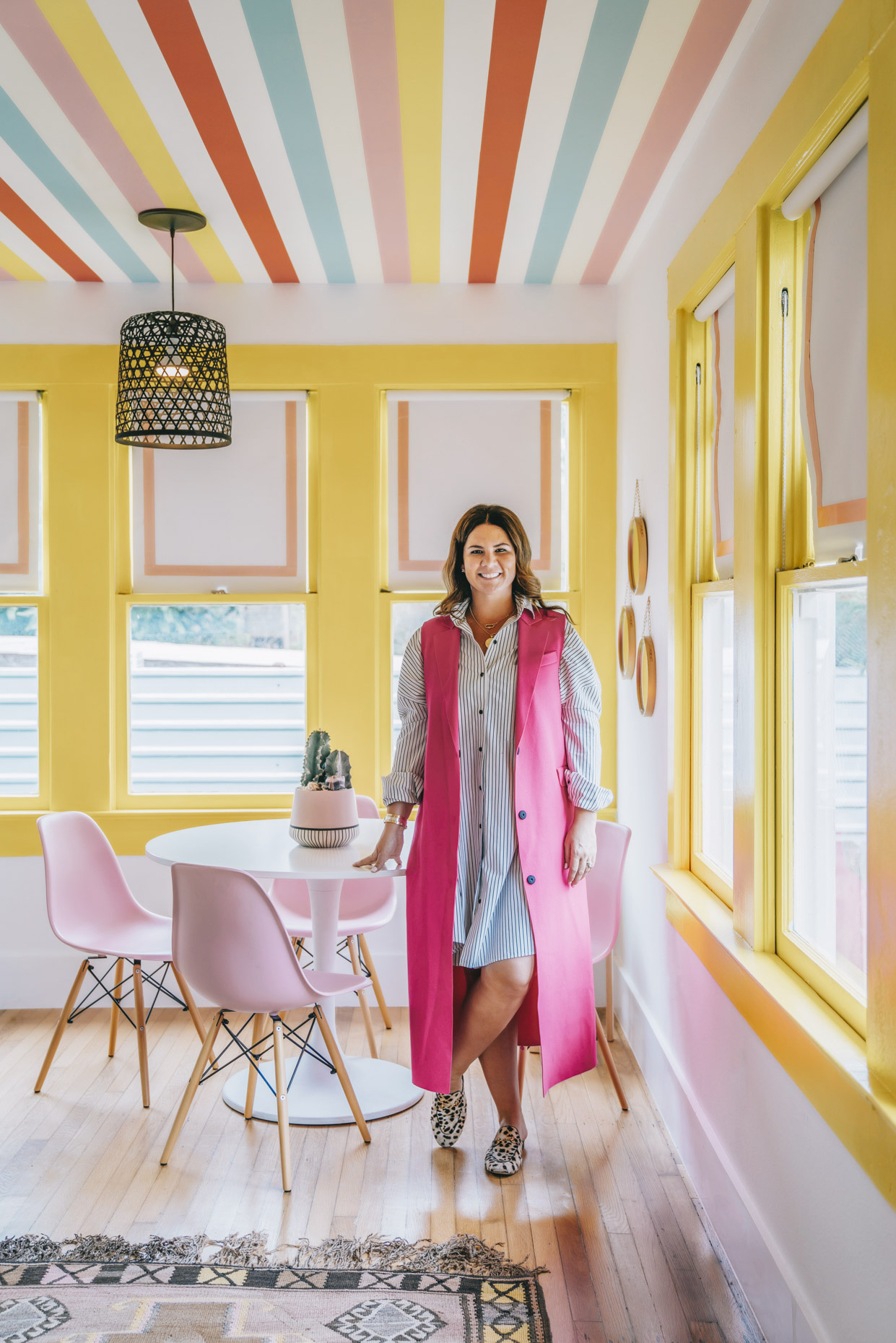 Portrait of textile designer Katie Kime in office with rainbow pink, yellow, blue paint