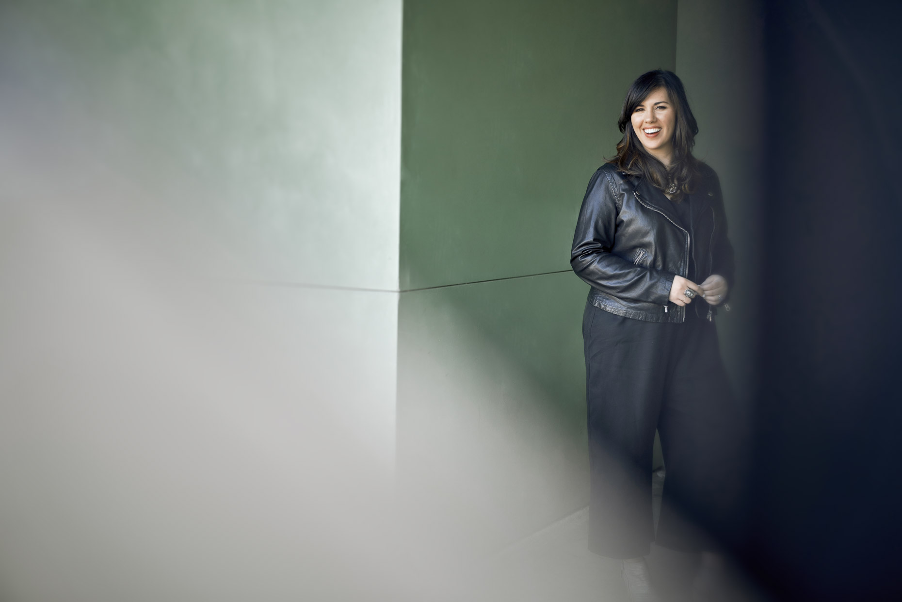 Portrait of smiling woman in black leather coat