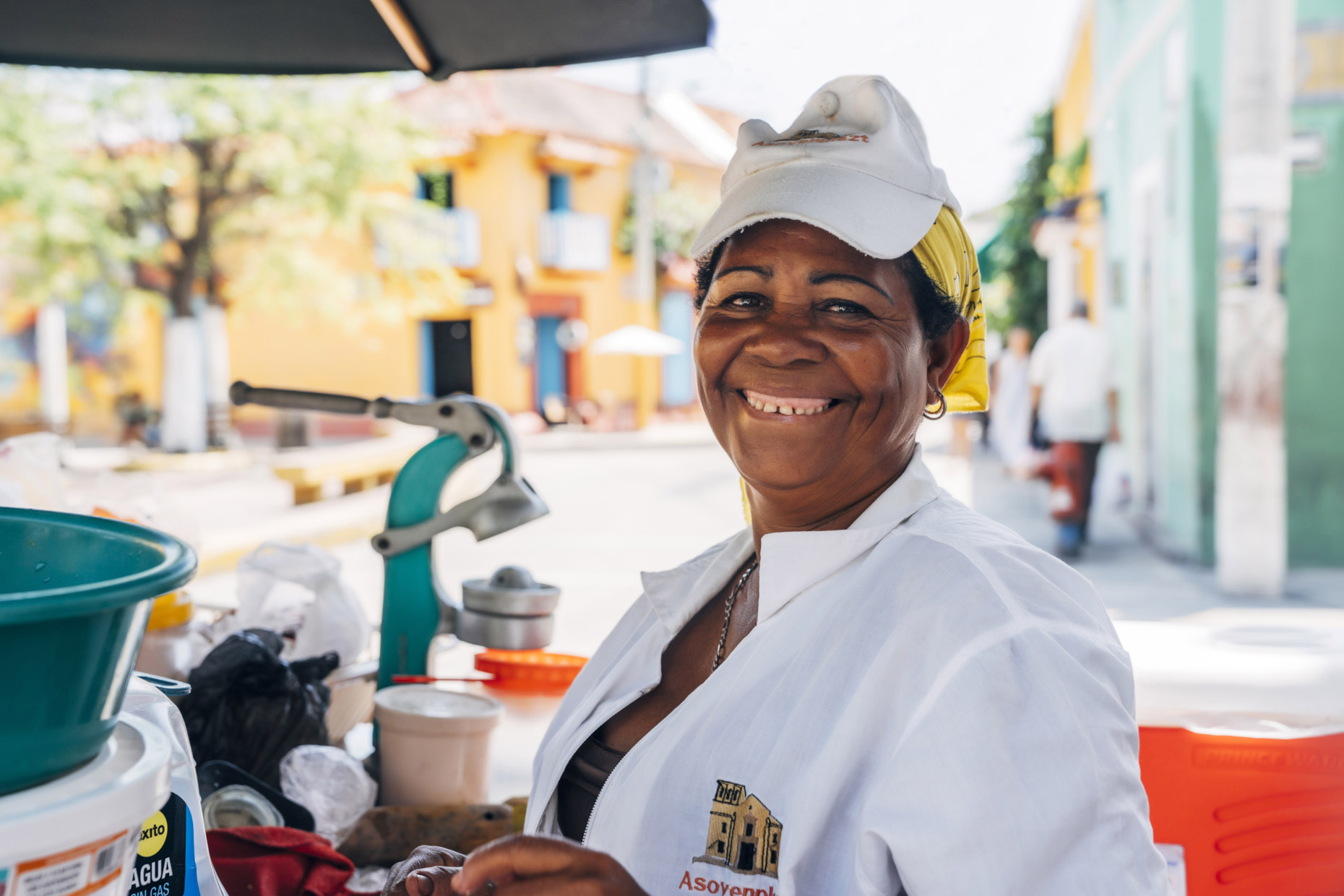 Portrait of smiling woman at street food cart in Cartagena, Colombia