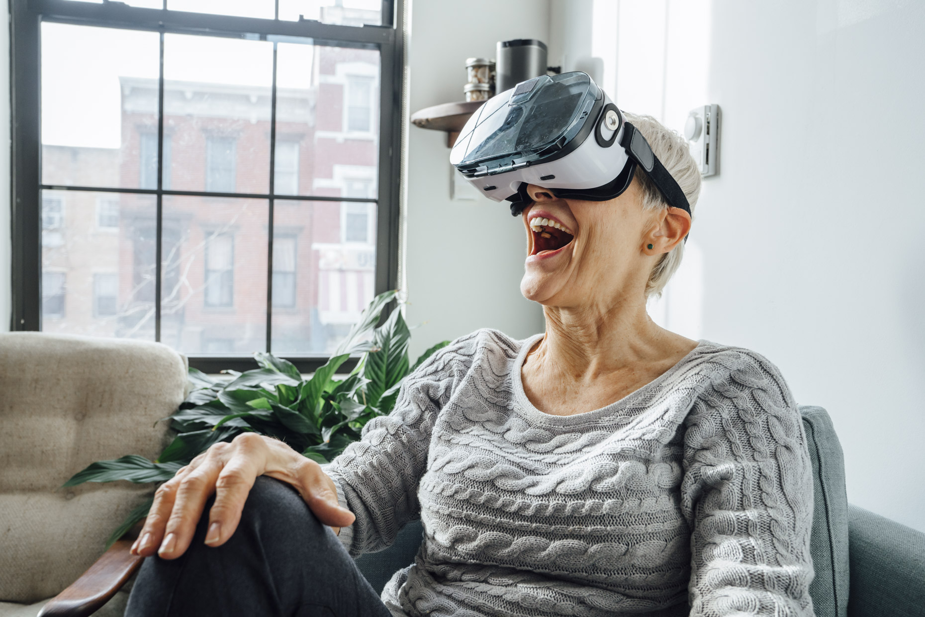 Senior woman excited about virtual reality glasses