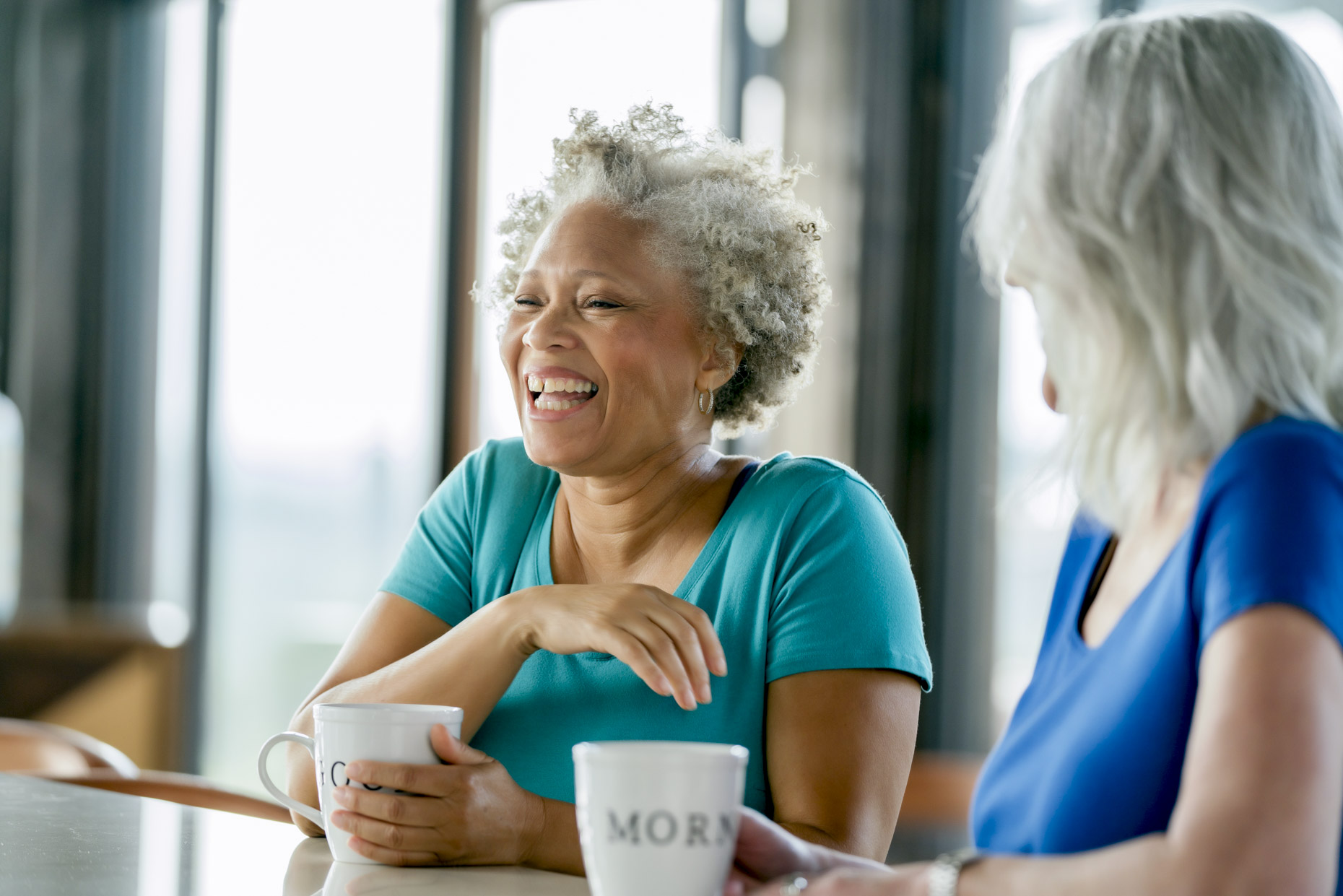 Senior women with grey hair  drinking coffee and laughing