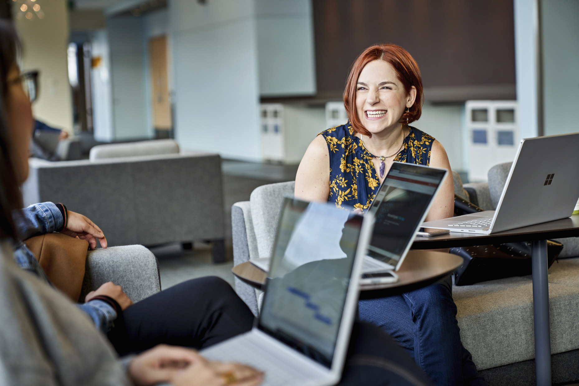 Smiling woman in casual tech business meeting