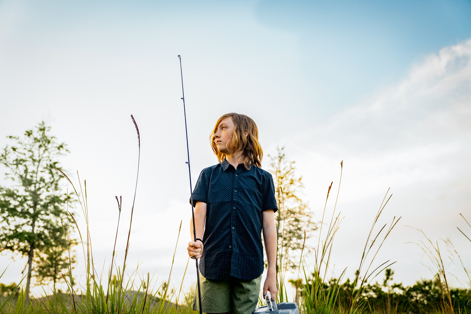Teen-boy-in-nautre-with-fishing-pole-tackle-box-042623_WILDLIGHT_SCENE7_10712