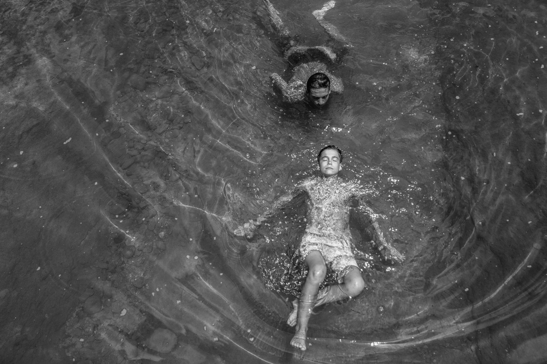 Teen boys swimming in lake 