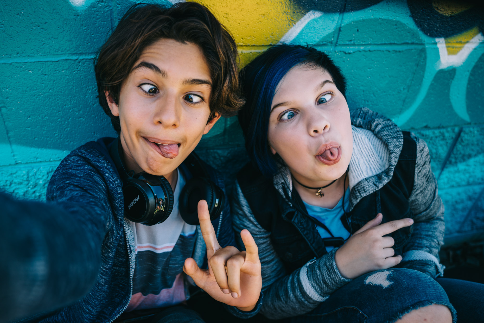 Teens making goofy faces while taking selfie photo