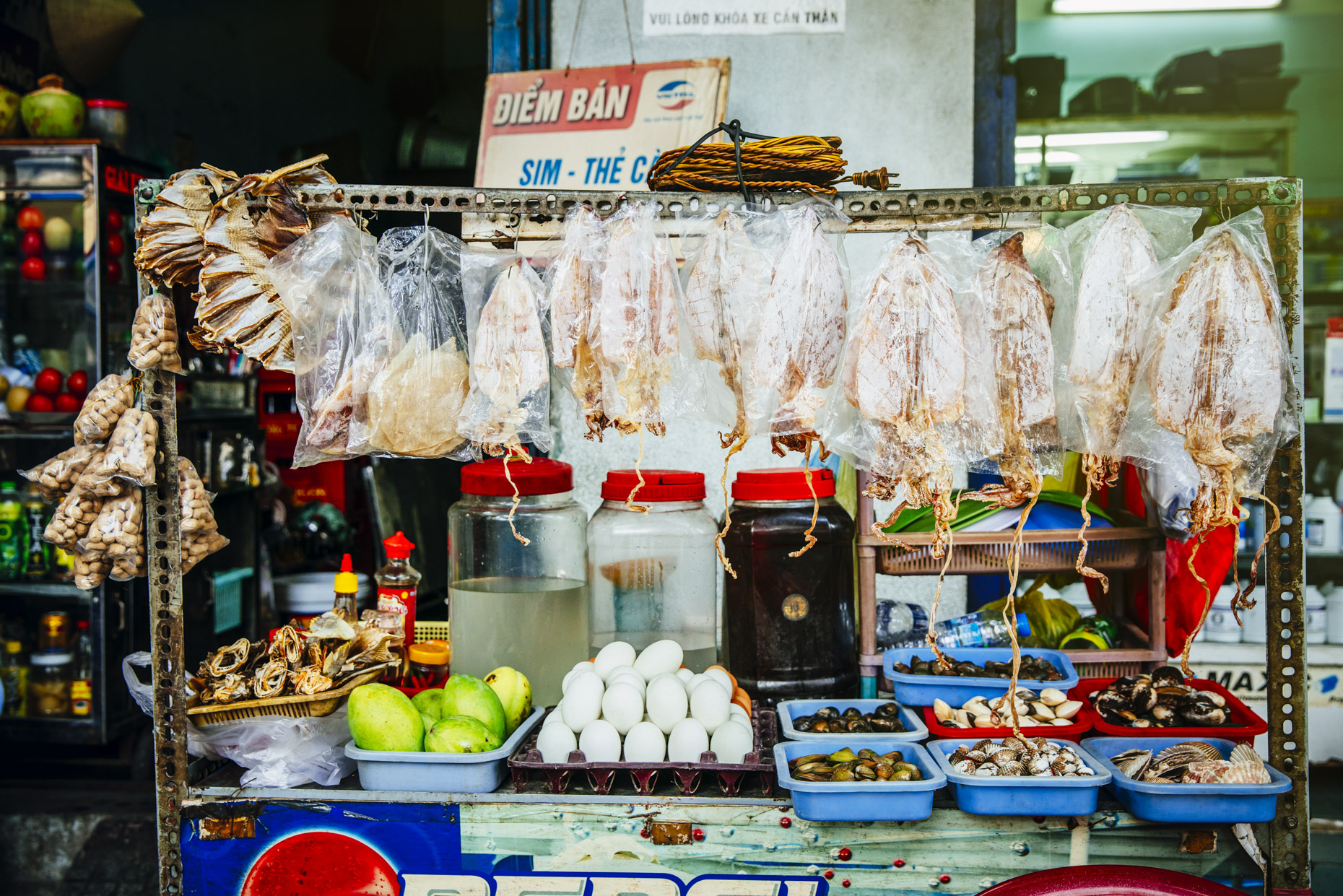 Varied of dried and fresh fish, eggs, and produce on street vendor