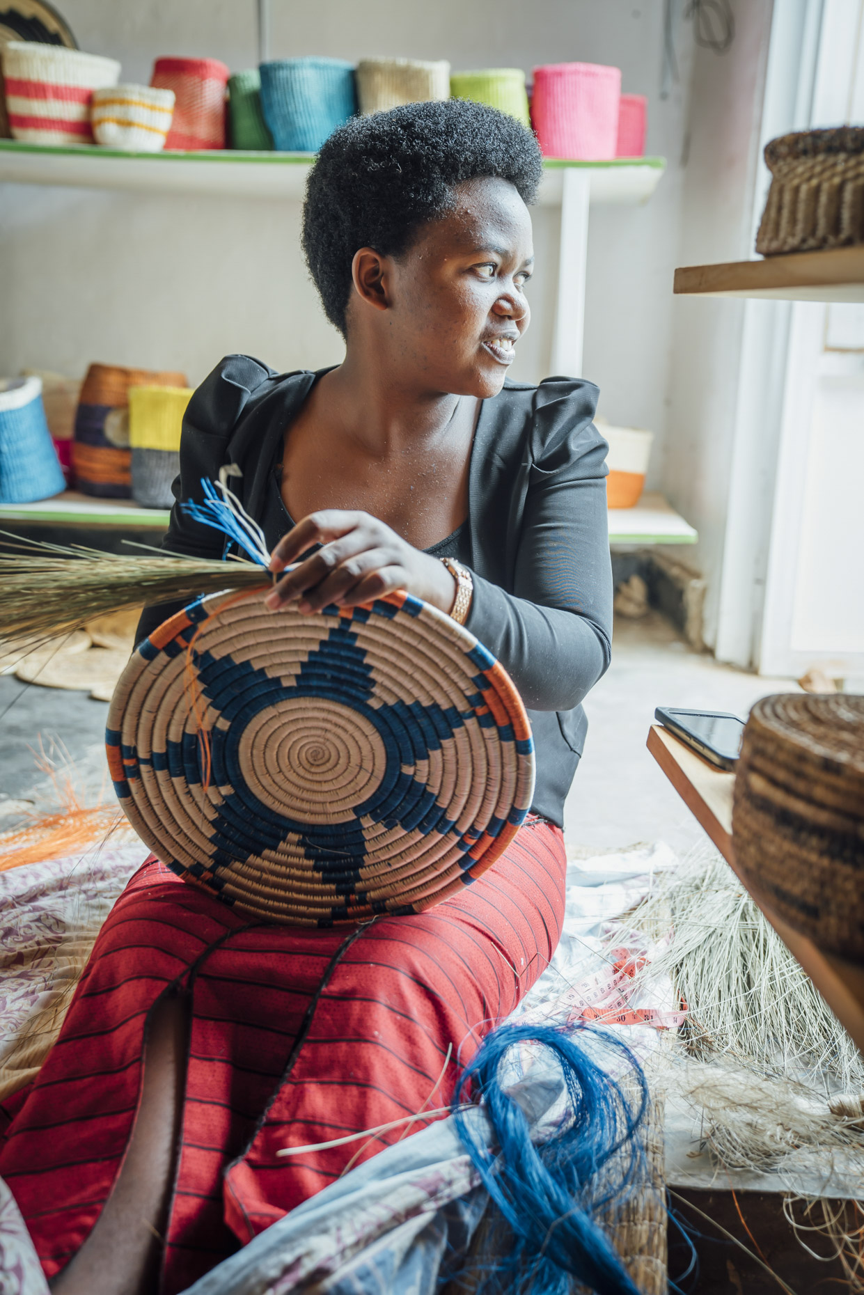 Woman hand crafting grass basket in Kigali Rwands 