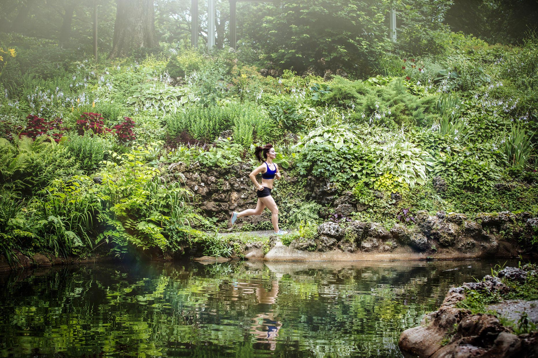 Woman running through lush park in sprintime