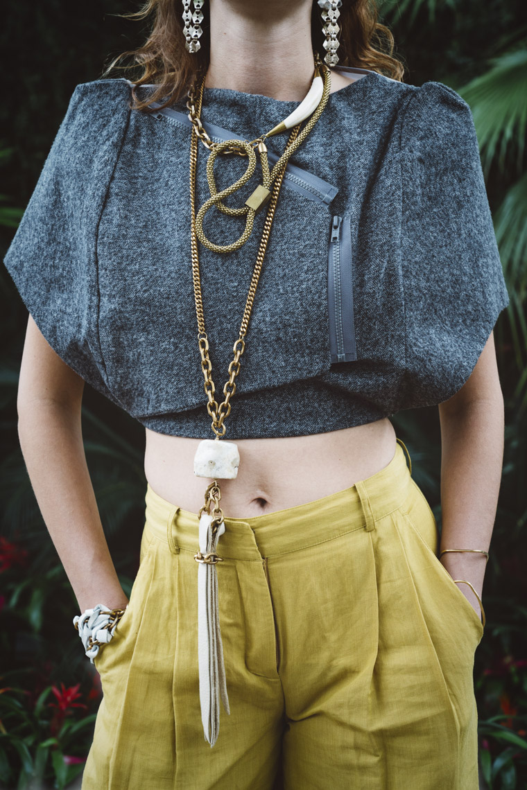 Woman wearing long brass leather stone necklace
