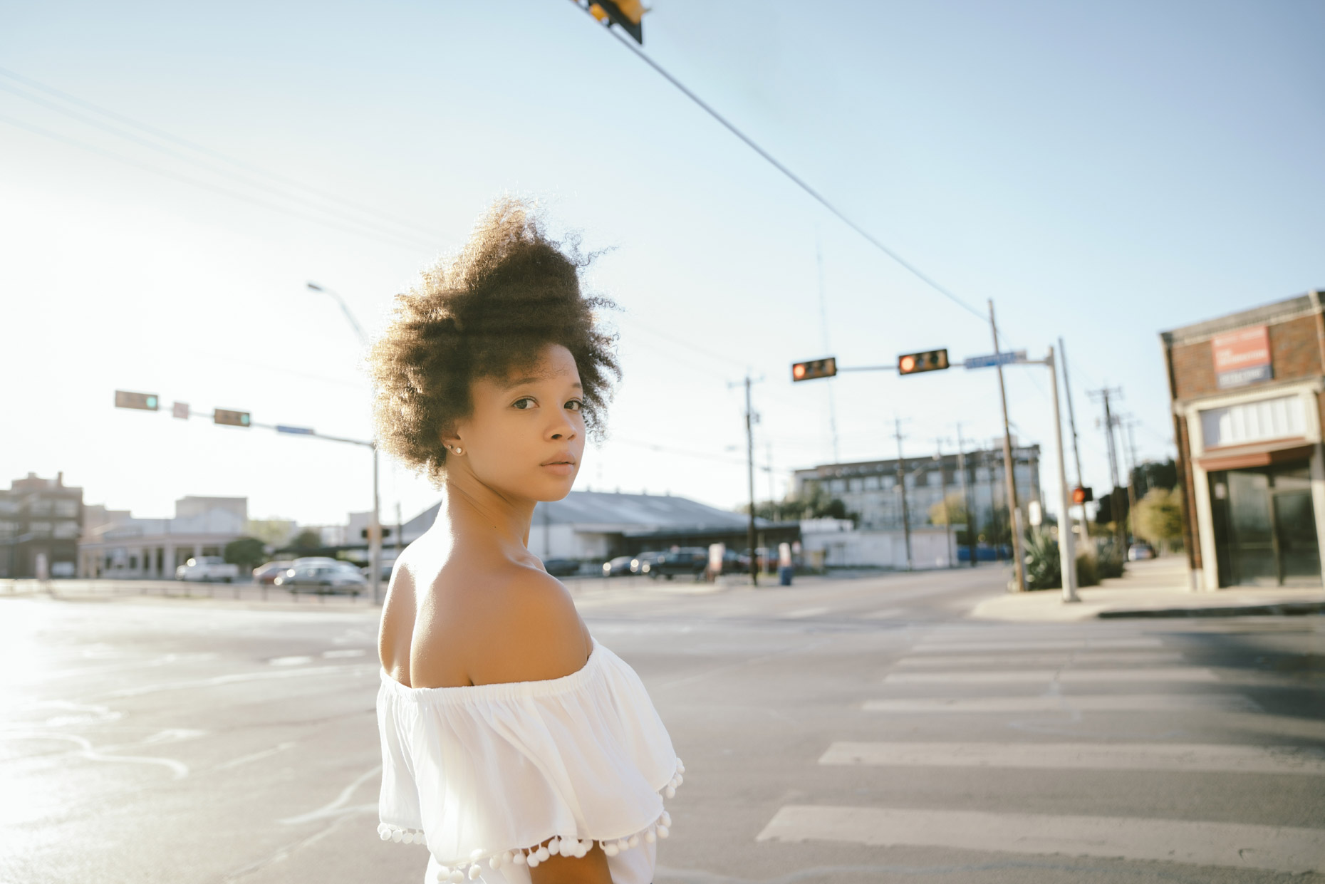Woman-white-off-the-shoulder-top-standing-in-intersection-is201711271425