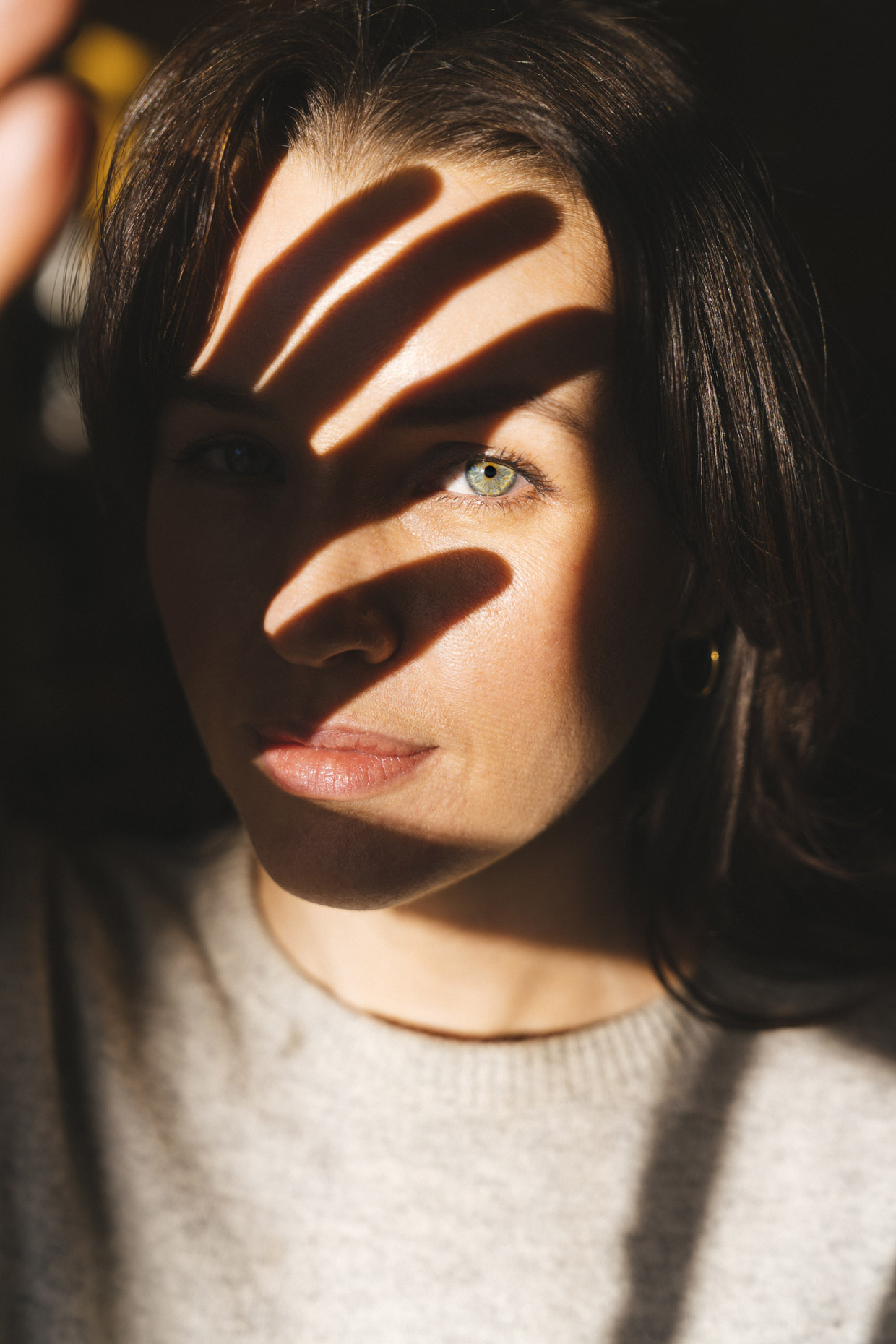 Woman with shadow of hand across face