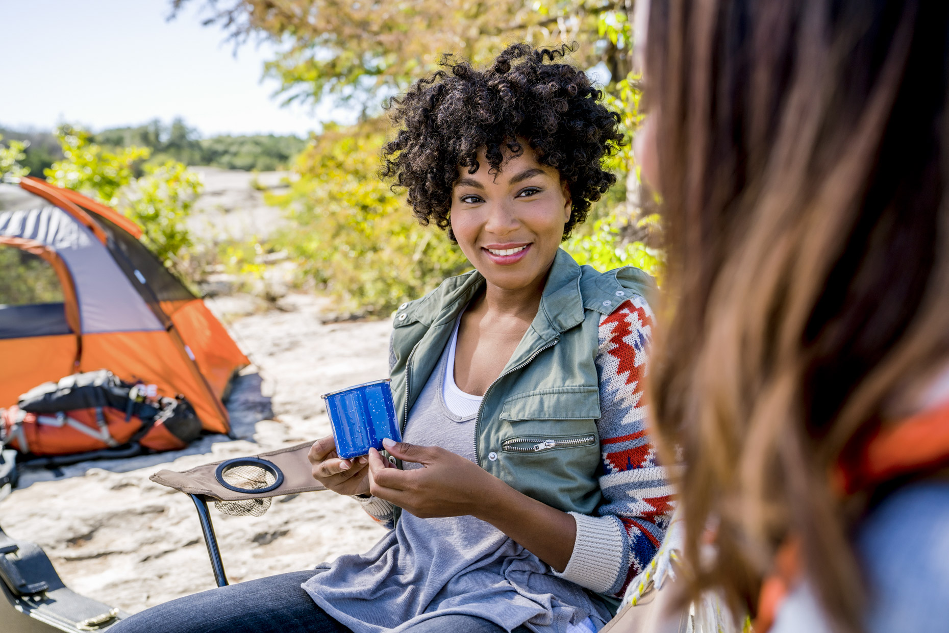 Women sitting in campsite talking