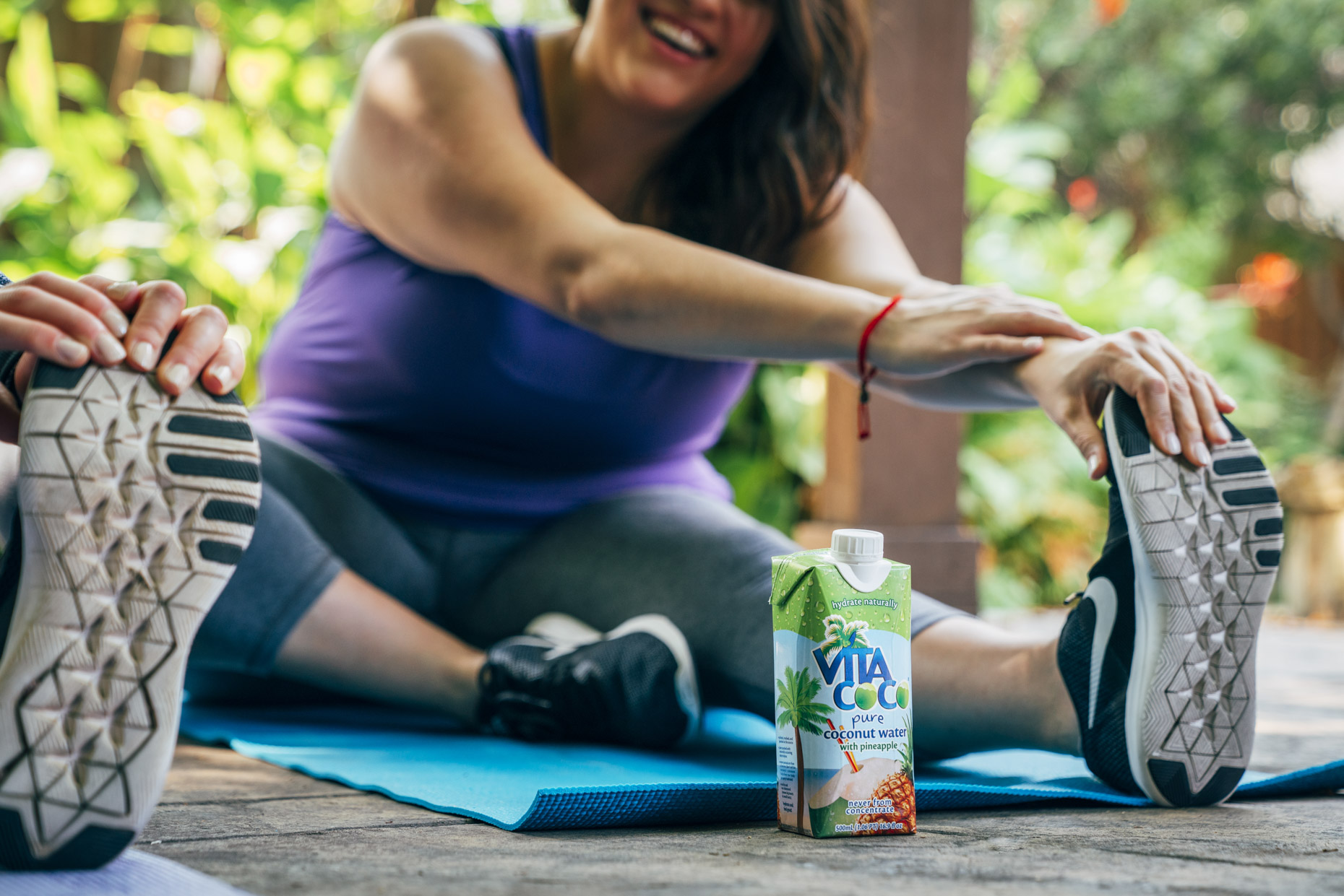 Women stretching on yoga mats with vita coco coconut water