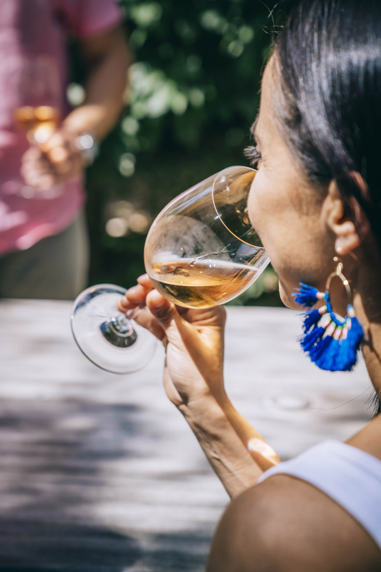 Profile of woman drinking glass of rose wine