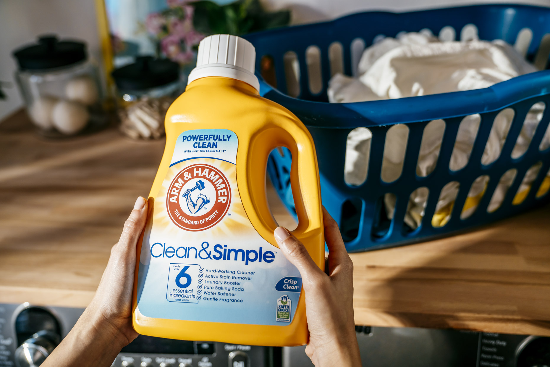 Woman holding bottle of arm and hammer laundry detergent